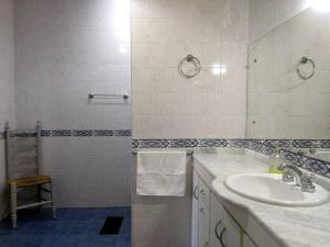 a white bathroom with a sink and a shower at Roque 4047 in San Juan +10 photos