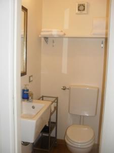 a bathroom with a white toilet and a sink at Lo Studio in Terranuova Bracciolini