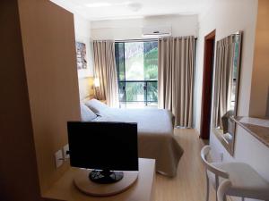 TV a/nebo společenská místnost v ubytování Itajubá Flat Hotel