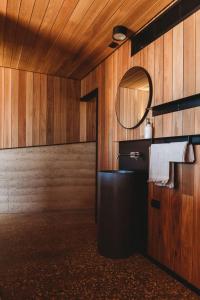 a bathroom with a sink and a mirror at Yonder Studio at Basalt Luxury Accommodation in Canobolas
