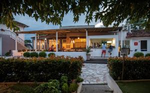 a house with people walking in the front yard at Camping Stolos in Limín Litochórou