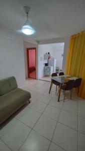 a living room with a couch and a table at Lindo Apartamento perto da praia in Rio das Ostras +80 photos