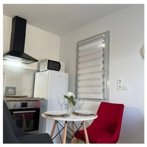 a kitchen with a table and two chairs with wine glasses at Home Sweet Home in Gex