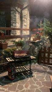 a grill in front of a stone building with plants at GINESTRA Apartment in San Potito