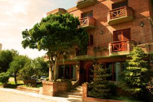 a red brick building with a tree in front of it at Hotel Olimpia in Ostende