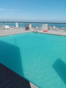 a large swimming pool with a view of the city at Departamento Iquique Nuevo Centro in Iquique