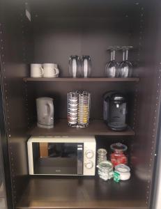 a kitchen with a microwave on a shelf at Large Kingsize ensuite in Kingswood, Bristol, BS15 in Kingswood