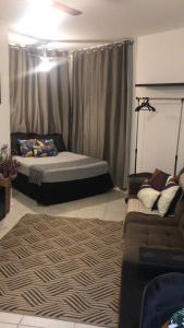 a living room with a bed and a couch at Reserva do Sahy-Mangaratiba Condado Loft Sol & Sal in Mangaratiba +27 photos