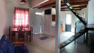 a living room with a table and a dining room at La Paisanita Gualeguaychú #lapaisanitagchu in Gualeguaychú