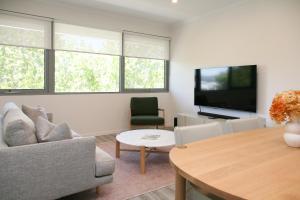 a living room with a couch and a tv at Hilton Executive Apartments in Keswick