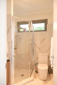 a bathroom with a shower and a toilet at Hilton Executive Apartments in Keswick