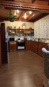 a large kitchen with wooden cabinets and an oven at La Cabaña de Mari in Oxapampa +37 photos