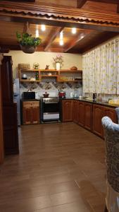 a large kitchen with wooden cabinets and an oven at La Cabaña de Mari in Oxapampa
