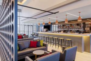 a lobby with couches and a bar at Travelodge Hotel Sydney Airport in Sydney