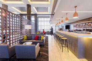 a lobby with couches and a bar in a building at Travelodge Hotel Sydney Airport in Sydney