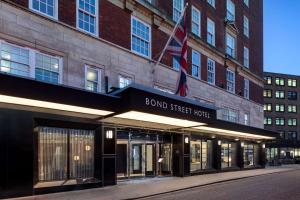 a building with a sign that reads bond street hotel at Radisson Blu Hotel, London Bond Street in London