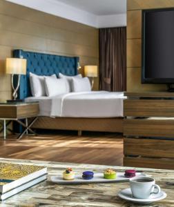 a hotel room with a bed and a tv at Radisson Blu Hotel, Istanbul Sisli in Istanbul