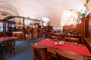 a restaurant with tables and chairs and a bar at Nové Adalbertinum in Hradec Králové