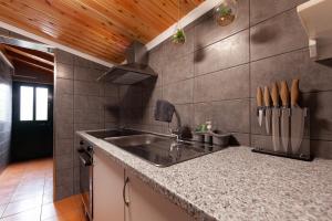 a kitchen with a sink and a counter top at Cantinho do Sossego in Madalena