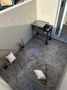 a room with two chairs and a piano on a floor at Orfila Apart 5 in Mendoza