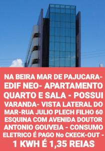 een groot bord voor een hoog gebouw bij NA BEIRA MAR DE PAJUCARA- EDIF NEO- APARTAMENTO QUARTO E SALA- TEM VARANDA - VISTA LATERAL DO MAR- RUA JULIO PLECH FILHO 60 ESQUINA COM AVENIDA DOUTOR ANTONIO GOUVEIA - CONSUMO ELETRICO É PAGO No CKECK-OUT 1KWH É 1,35 REIAS in Maceió