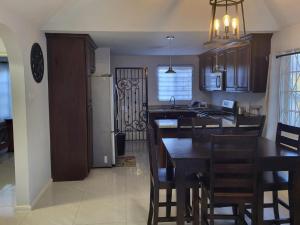 a kitchen and dining room with a table and chairs at Soleil Deluxe Hartland Home in Priory