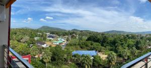 ein Blick von einem Balkon auf eine Stadt mit Bäumen in der Unterkunft AYA APARTMENTS IN MBC in Mai Khao Beach