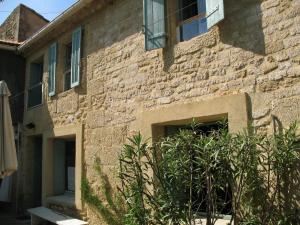 Un edificio de ladrillo con una ventana y plantas delante. en Mas Blauvac avec piscine, Entre Uzes Pont du Gard, en Vers Pont du Gard 13 fotos más
