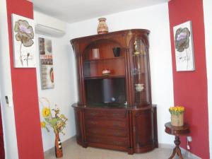 a large wooden cabinet with a television in a room at Apartamento Mare Nostrum in Denia