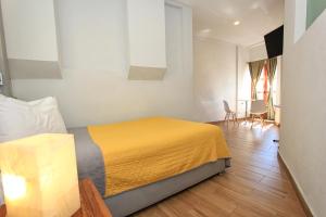 a bedroom with a bed and a table and chairs at Hotel Grand Guanajuato in Guanajuato