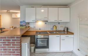 a kitchen with white cabinets and a sink at 1 Bedroom Nice Apartment In Niebll in Klixbüll