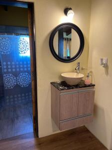 a bathroom with a sink and a mirror and a shower at Las Tres Rosas Casa de Campo in Falda del Carmen