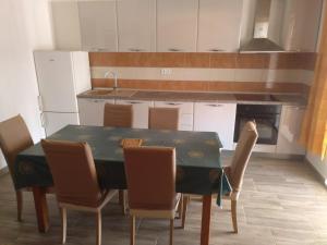 a kitchen with a table with chairs and a stove at Apartments with parking space Zavalatica, Korcula - 545 in Zavalatica