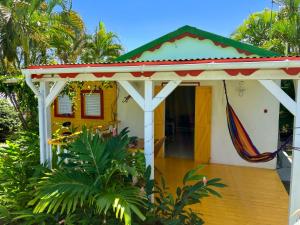 a small house with a gazebo at Gîte Zandoli Koko in Sainte-Anne