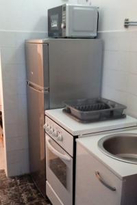 a kitchen with a stove and a sink in it at Family friendly house with a parking space Jastrebarsko, Prigorje - 20705 in Jastrebarsko