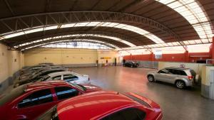 a parking lot with rows of cars in a garage at Hotel El Conde Naucalpan Only Adults in Mexico City