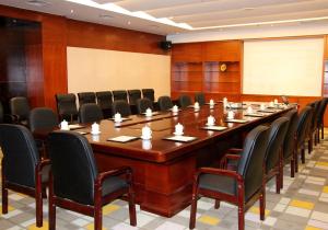 a large conference room with a large table and chairs at F·World Convention Center in Wuhan