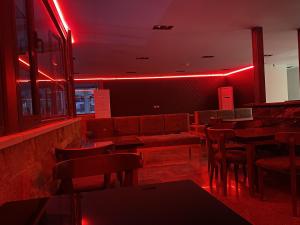 a restaurant with red lights and tables and chairs at The View Delta Hotel in Cairo