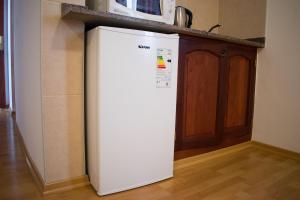 a white refrigerator in a kitchen next to a counter at Hostal Virgen del Rosario Cafayate in Cafayate