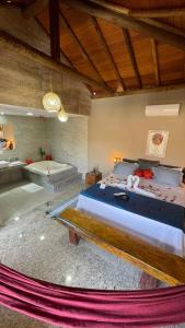 um quarto com uma cama grande e uma banheira em Pousada Adega Cipo em Serra do Cipó