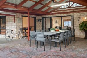 a patio with a table and chairs and a bike at The Shamrock Luxury Retreat 