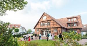 a group of people standing outside of a building at Hotel Hennies in Isernhagen