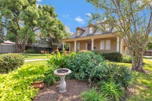 a house with a bird bath in the yard at The Gauthier House Downtown Lafayette Louisiana in Lafayette