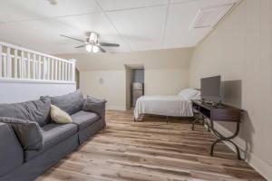 a living room with a couch and a bed at The Gauthier House Downtown Lafayette Louisiana in Lafayette