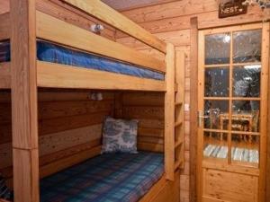 a couple of bunk beds in a log cabin at Studio Montgenèvre, 1 pièce, 4 personnes - FR-1-266-183 in Montgenèvre