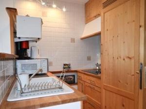 a kitchen with a dish drying rack on the sink at Studio Montgenèvre, 1 pièce, 4 personnes - FR-1-266-183 in Montgenèvre