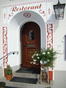 an entrance to a building with a wooden door at Crusch Alba in Scuol