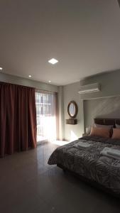 a bedroom with a large bed and a window at Bella Luxury Suite II in Paralia Katerinis