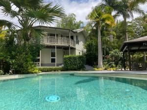 a large swimming pool in front of a house at Clearwater estate in Doonan