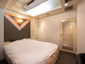 Postel nebo postele na pokoji v ubytování Tabist Hotel Rakuserina